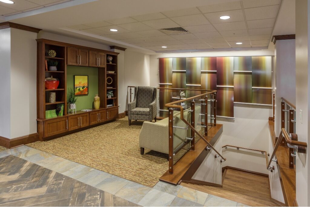 A Common Area With Walls, Flooring, And Staircase Refinished By Foggy Ridge Interiors