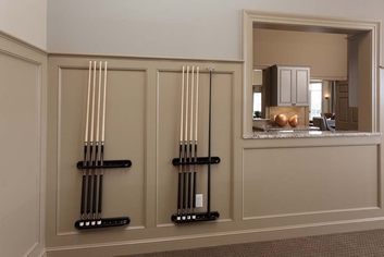 A finished basement that was remodeled by Foggy Ridge contractors that includes bar, and pool stick rack